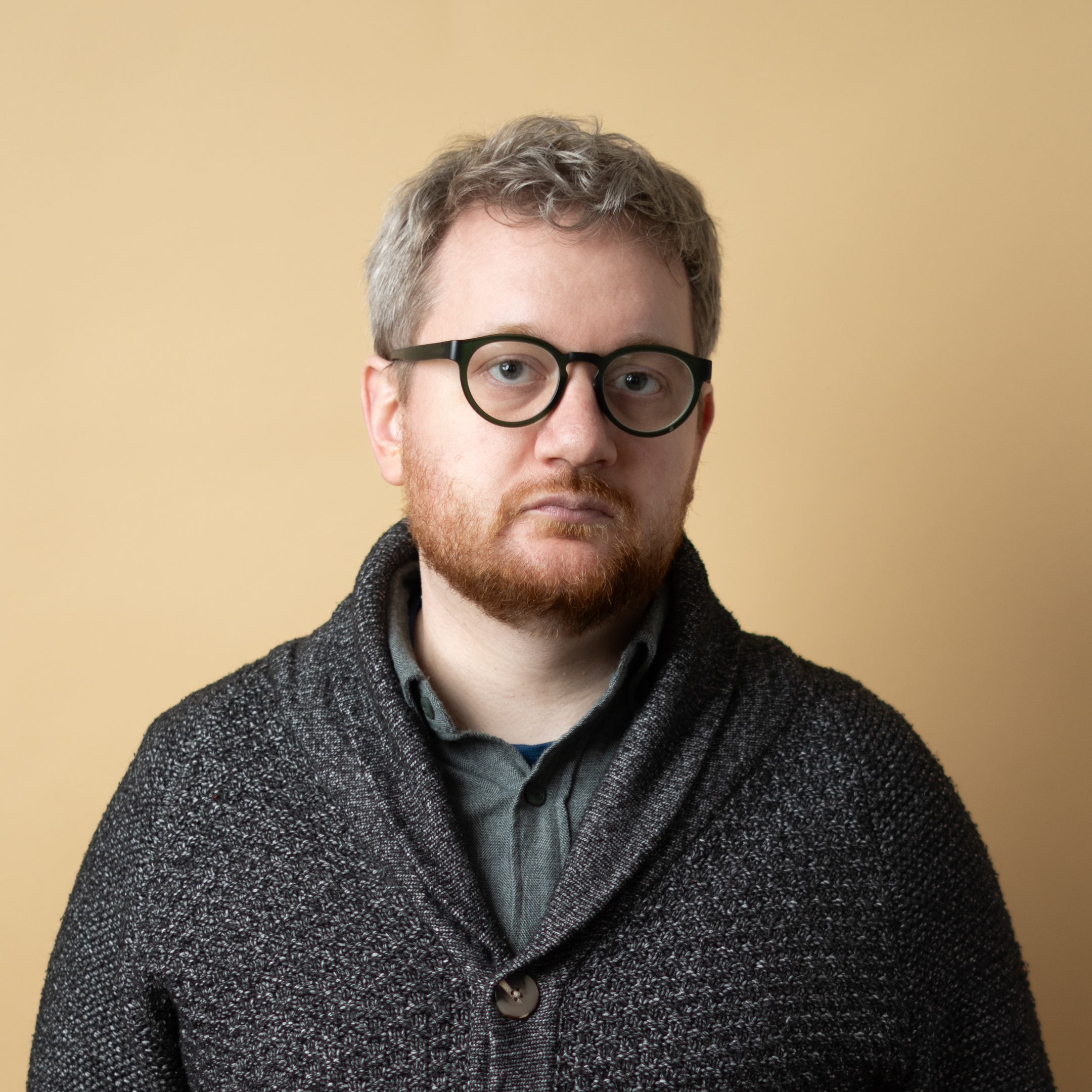 A square headshot of Zack looking like a disappointed dad