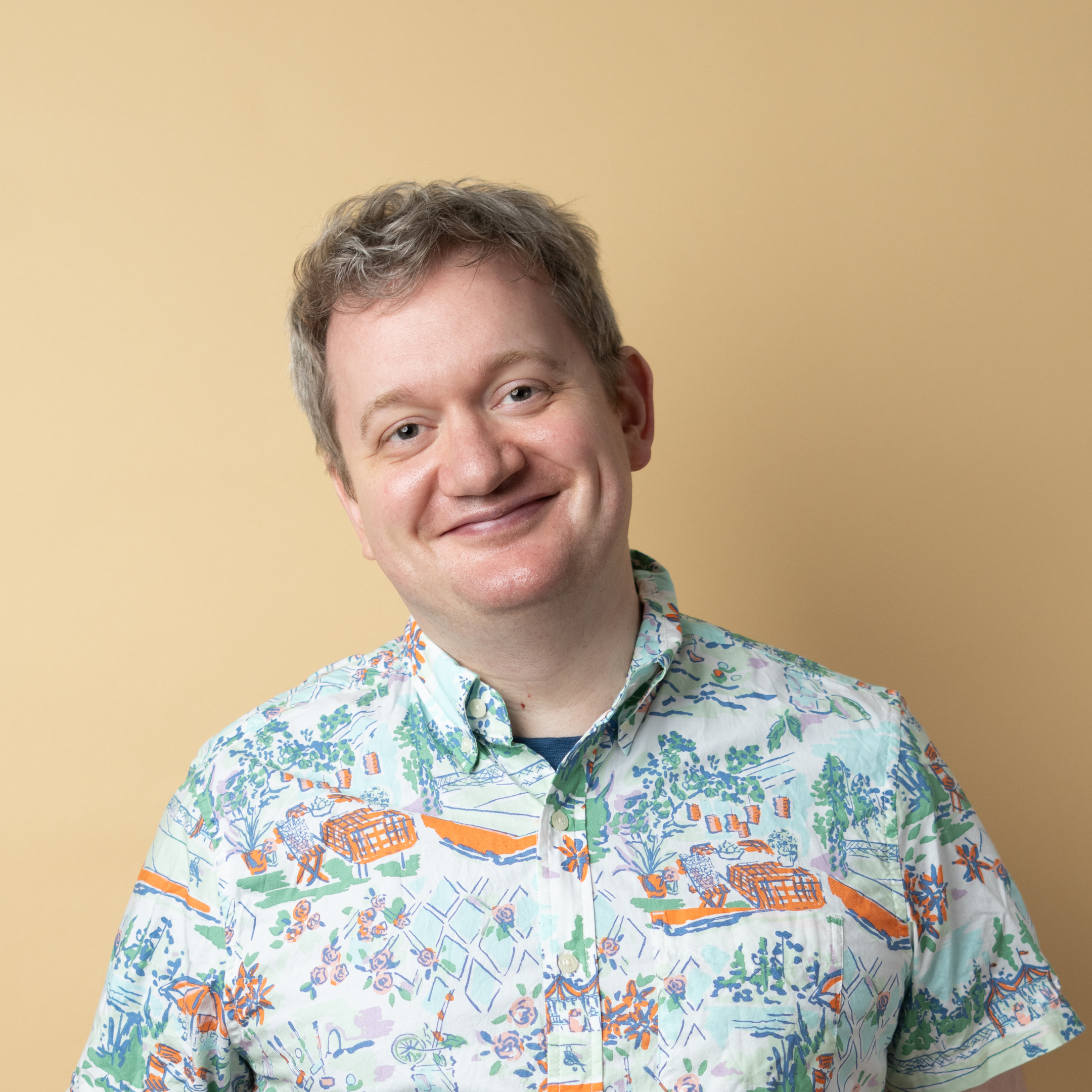 A square headshot of Zack smiling